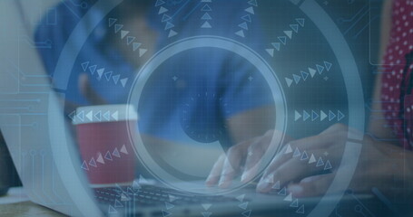 Typing woman in polka dot blouse entering code at wooden office table, with laptop, coffee cup