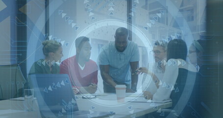 Discussing six professionals leaning over documents in office, with laptop, coffee and tech overlay