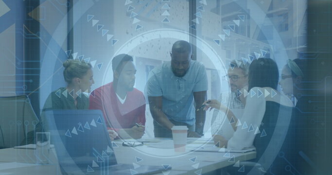 Discussing six professionals leaning over documents in office, with laptop, coffee and tech overlay