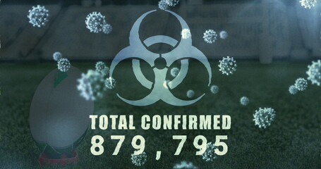 Displaying biohazard symbol with TOTAL CONFIRMED 879,795 on pitch with virus particles, teed ball