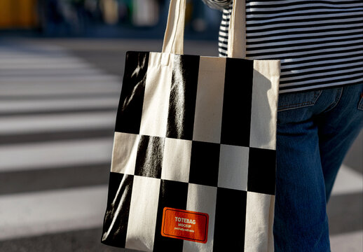 Tote Bag Mockup Being Carried Across the Street