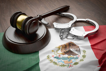 Gavel and Handcuffs Resting on a Tattered and Dirty Mexican Flag.