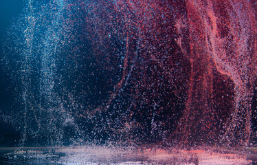 Water droplets create mesmerizing patterns in a dark environment