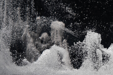 Water droplets create mesmerizing patterns in the air during a spray demonstration