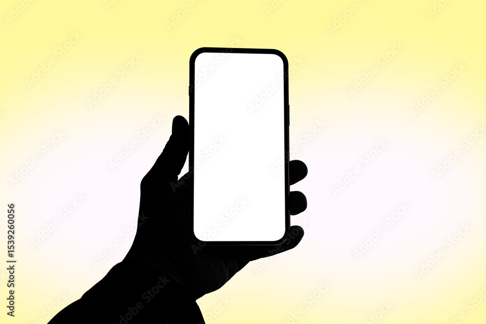 Poster silhouette of a hand holding a modern smartphone with a blank white screen, isolated on a soft yello