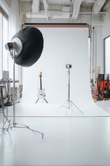 Modern Professional Photography Studio with Acoustic Guitar and Versatile Equipment Setup.