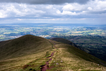 Walking on Cefn Cwm Llwch ridge in summer in the national park of Brecon Beacons or Bannau Brycheiniog, Powys, Wales