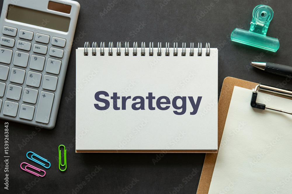 Poster there is notebook with the word strategy. it is as an eye-catching image.