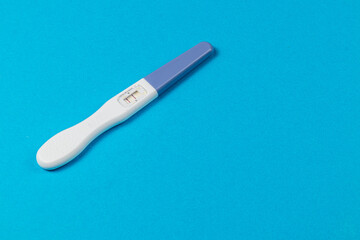Pregnancy test on a blue background ready for results