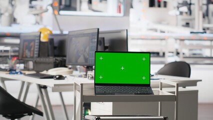 Isolated screen monitor in photovoltaics factory used to oversee performance of manufacturing solar panels. Chroma key pc in empty industrial facility used to inspect solar plant machinery.