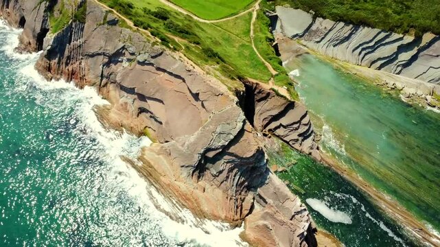 Breathtaking aerial perspectives of zumaia's flysch cliffs, showcasing the unique geological formations and the dynamic interplay of land and sea on the basque country coastline