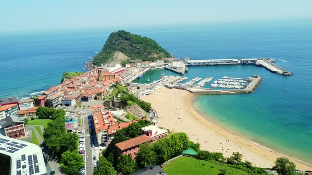 Getaria, a picturesque basque town, unfolds from a high vantage point, showcasing its harbor, beach, and iconic mount san anton
