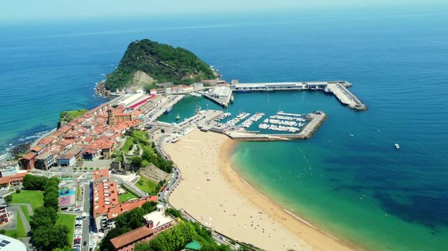 Aerial view of getaria town, port, beach and san anton mountain in gipuzkoa, basque country, spain, during a sunny summer day