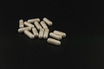 Natural health supplements arranged on a dark surface