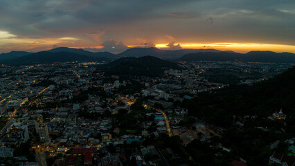 Sunset over tropical mountain city in Thailand