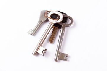 Old worn metal keys key bundle on white background, vintage house keyring bundle different shapes, isolated collection of keys together, household garage, basement, house key set, objects cut out