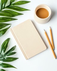 A serene workspace featuring a minimalist notebook, neatly placed pencils, and a cup of coffee, complemented by lush green leaves, ideal for inspiration.