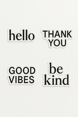 Four Stickers With Positive And Uplifting Messages: "Hello," "Thank You," "Good Vibes," And "Be Kind." The Stickers Are In A Simple Black And White Style.