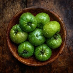 Vibrant green tomatoes in a wooden bowl, showcasing fresh, organic produce and culinary appeal