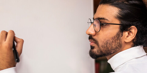 English Lesson. Young Indian Teacher Writing English Language Grammar Rules On Blackboard Teaching During Class Indoors. Education And Knowledge Concept. Selective Focus