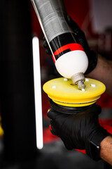 Applying compound to yellow polishing pad. Car detailing and paint correction preparation....
