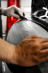 Wrapping vinyl requires perfect tension and accurate blade work for high-end detailing. Vinyl film...