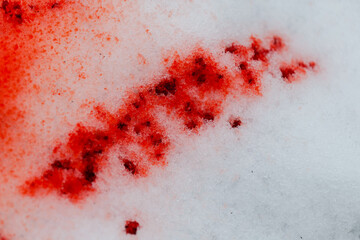 Bloody traces of crime and street fight.Crime Scene.Red blood wallpaper.Red Stain on Snowy Ground