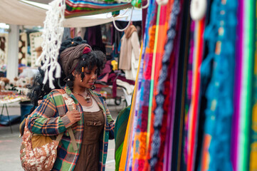 Tourist choosing colorful handcrafted souvenirs at street market