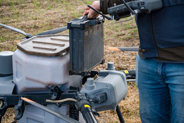 Agricultural technicians replace the battery of a large agricultural drone. Smart farm concept with agricultural technology.