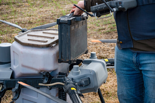 Agricultural technicians replace the battery of a large agricultural drone. Smart farm concept with agricultural technology.