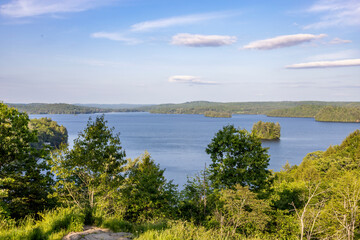 A breathtaking view from Lion's Lookout in Huntsville, Ontario, capturing lush forests, a serene lake, and a vast sky.