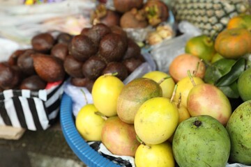 Different fresh exotic fruits at market, closeup