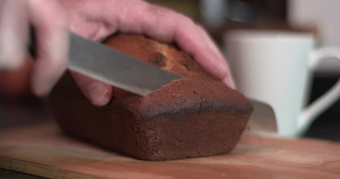 Fresh baked bread cake loaf sliced by knife cup of tea coffee