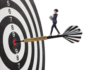Goal achievement, business success and targeting. Businesswoman walking on dart sticking in center...