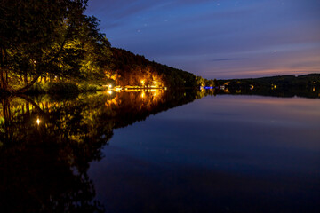 A peaceful evening at Peninsula Lake in Huntsville, Ontario, capturing serene reflections under a starry sky.