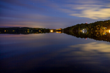 A serene twilight view over Peninsula Lake in Huntsville, Ontario, capturing the tranquil reflections and natural beauty of the landscape.