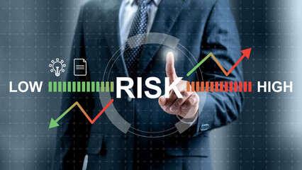 Businessman touching risk assessment icon. Technology innovation on a virtual screen. Concept of risk management
