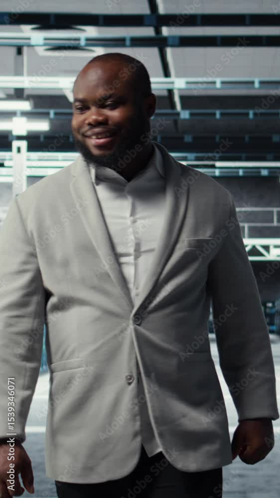 Poster vertical video smiling employee walking in high tech data center with machines powering networks, ru