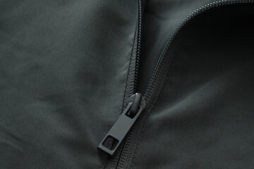 close up of jacket zipper on color background