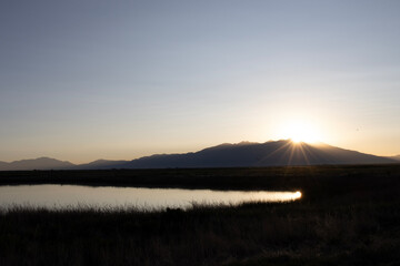 Sun bursts over Blanca Peak in the Sangre de Cristo Mountains from Alamosa National Wildlife Refuge in southern Colorado