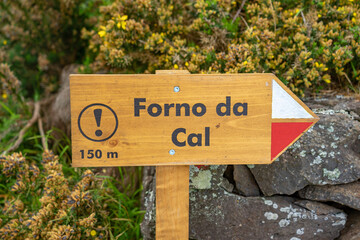 Direction sign on pedestrian path to lime kiln 150 meters away on the Azorean island of Santa Maria.
