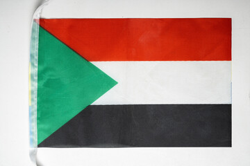 Closeup view of the Sudan national flag isolated over a white background. Concept of government and...