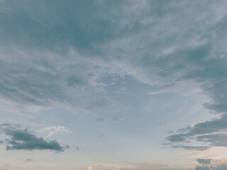 Dramatic overcast sky with gray fluffy clouds creating peaceful yet moody atmospheric background...