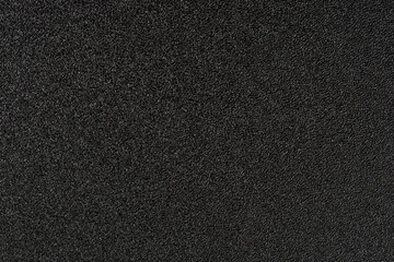 Shiny wrapper paper. black sandpaper texture background. 
