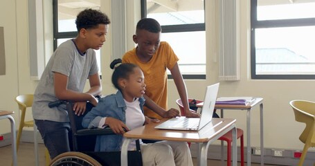 Multiracial students using on laptop in classroom, smiling and engaged in learning, at school - Powered by Adobe