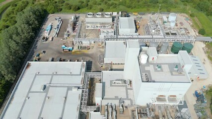 Aerial drone shot large factory refinery processing facility   cooling fans quantum computing data centre industrial piping near Immingham England UK business warehouse district  - Powered by Adobe