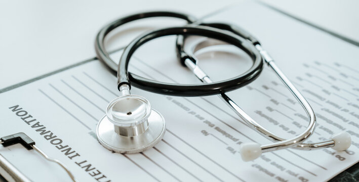A stethoscope rests on a patient information form, symbolizing medical care, diagnosis, and healthcare documentation.