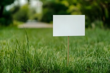 Blank Sign on Stick in Grass: Minimalist Outdoor Display for Natural Branding Concepts