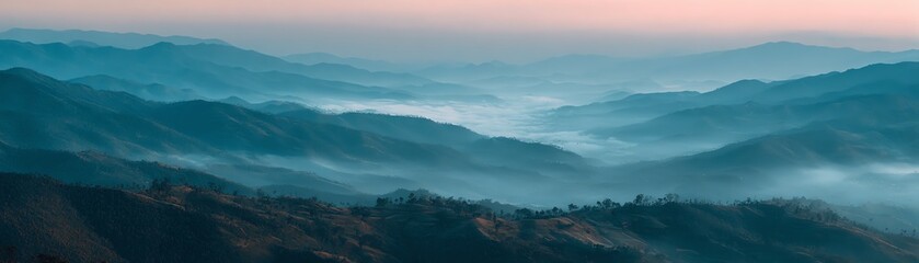 Fototapeta premium Serene mountain landscape with misty valleys at dawn, soft pastel colors.