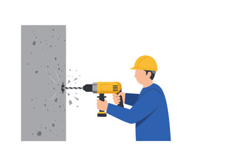 A construction worker wearing a helmet drills into a concrete wall